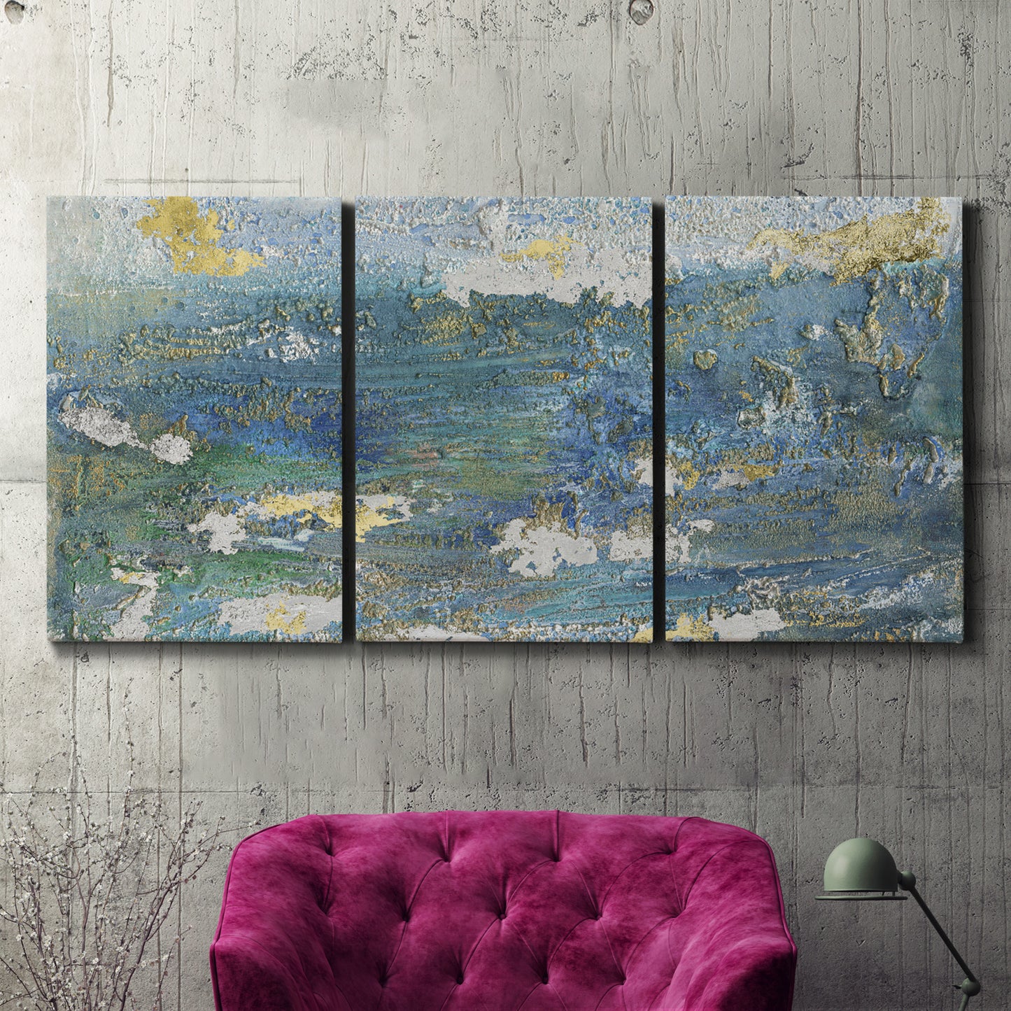 Three-panel canvas wall art featuring sparkling abstract sea surface, displayed in a living room above a suede accent chair.