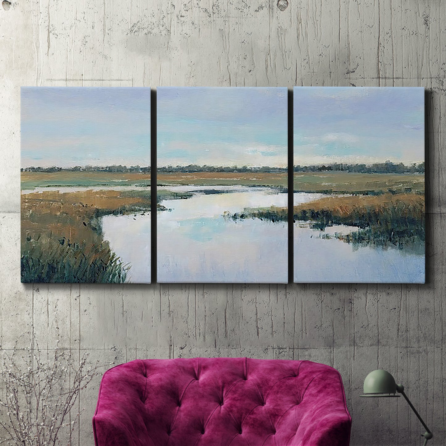 Three-panel canvas wall art featuring coastal plain meeting open water, displayed in a living room above a suede accent chair.