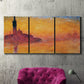 Three-panel canvas wall art featuring venetian church at twilight, displayed in a living room above a suede accent chair.