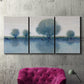 Three-panel canvas wall art featuring calm afternoon river reflection, displayed in a living room above a suede accent chair.
