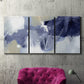 Three-panel canvas wall art featuring abstract sky break composition, displayed in a living room above a suede accent chair.
