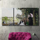 Three-panel canvas wall art featuring garden house beside river, displayed in a living room above a suede accent chair.