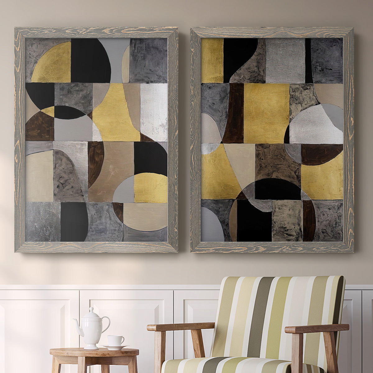 Set of two gray barnwood framed canvas prints depicting two structured modern abstracts featuring interlocking black gray cream and gold geometric sections above a sideboard in a cozy sitting room.