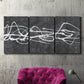 Three-panel canvas wall art featuring minimal abstract frequency lines, displayed in a living room above a suede accent chair.