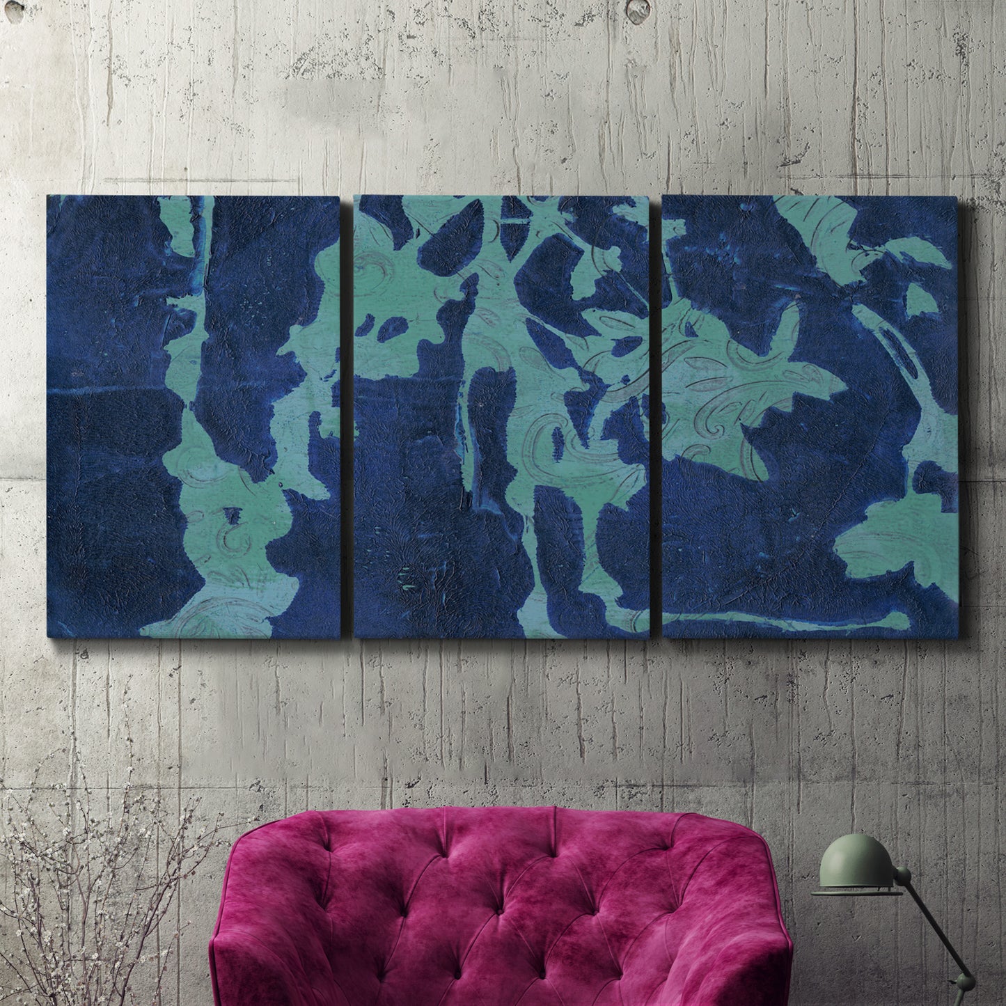 Three-panel canvas wall art featuring abstract floral shapes, displayed in a living room above a suede accent chair.