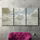 Three-panel canvas wall art featuring whimsical vertical tree landscape, displayed in a living room above a suede accent chair.