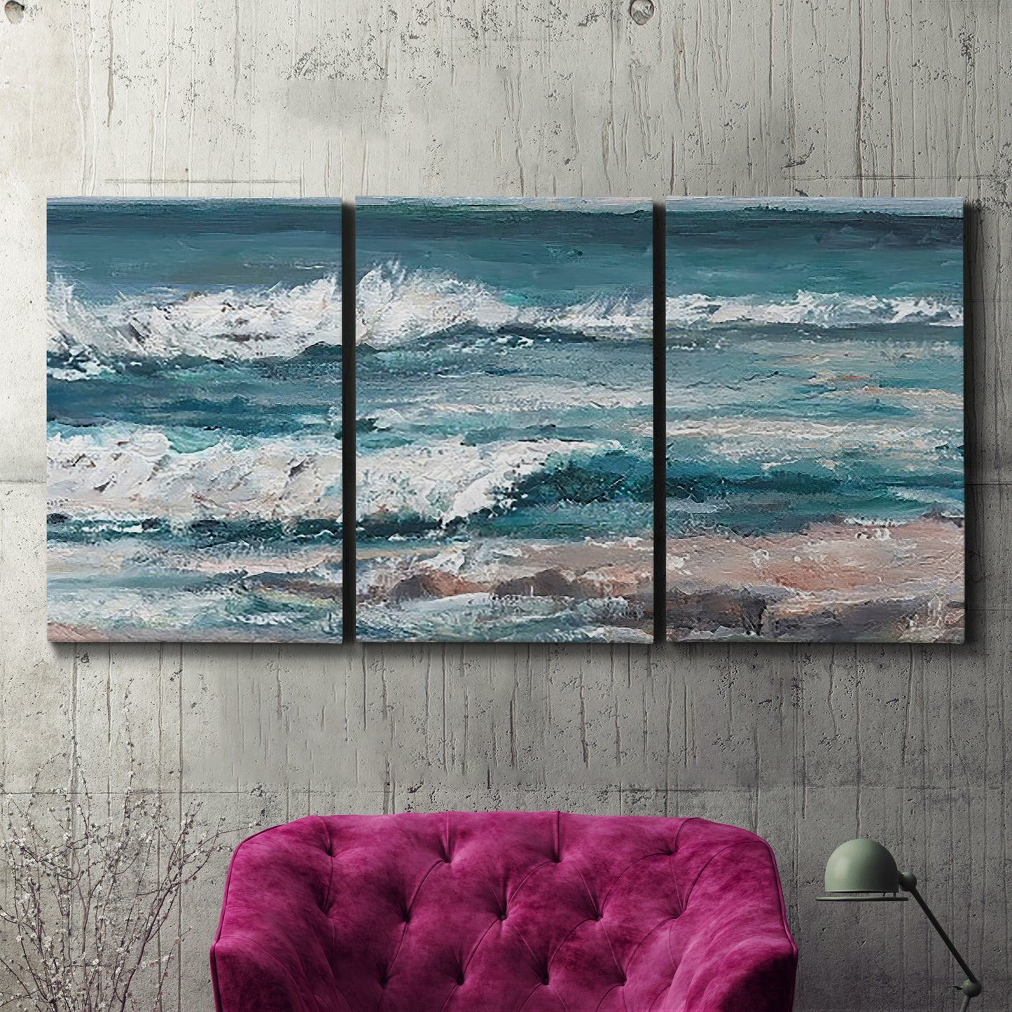 Three-panel canvas wall art featuring crashing ocean waves along shoreline, displayed in a living room above a suede accent chair.