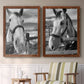 Set of two maple barnwood framed canvas prints depicting two modern equestrian photography featuring black-and-white close-up portraits of horses at fences above a sideboard in a cozy sitting room.