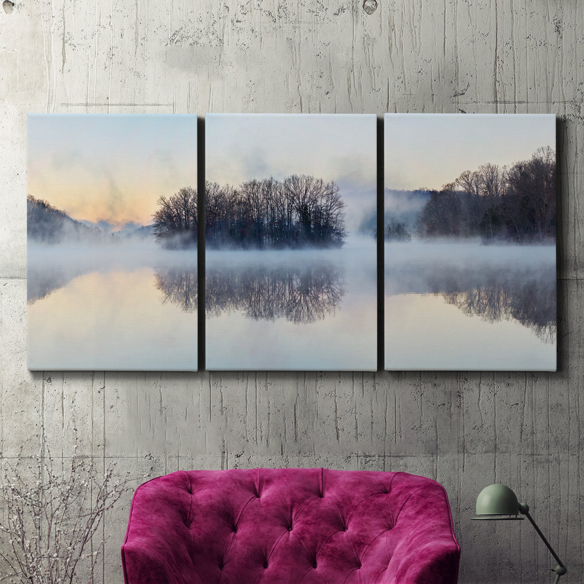 Three-panel canvas wall art featuring misty water landscape photograph, displayed in a living room above a suede accent chair.