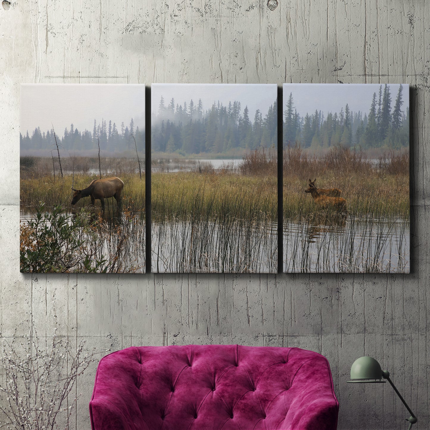 Three-panel canvas wall art featuring wildlife walking through open field, displayed in a living room above a suede accent chair.