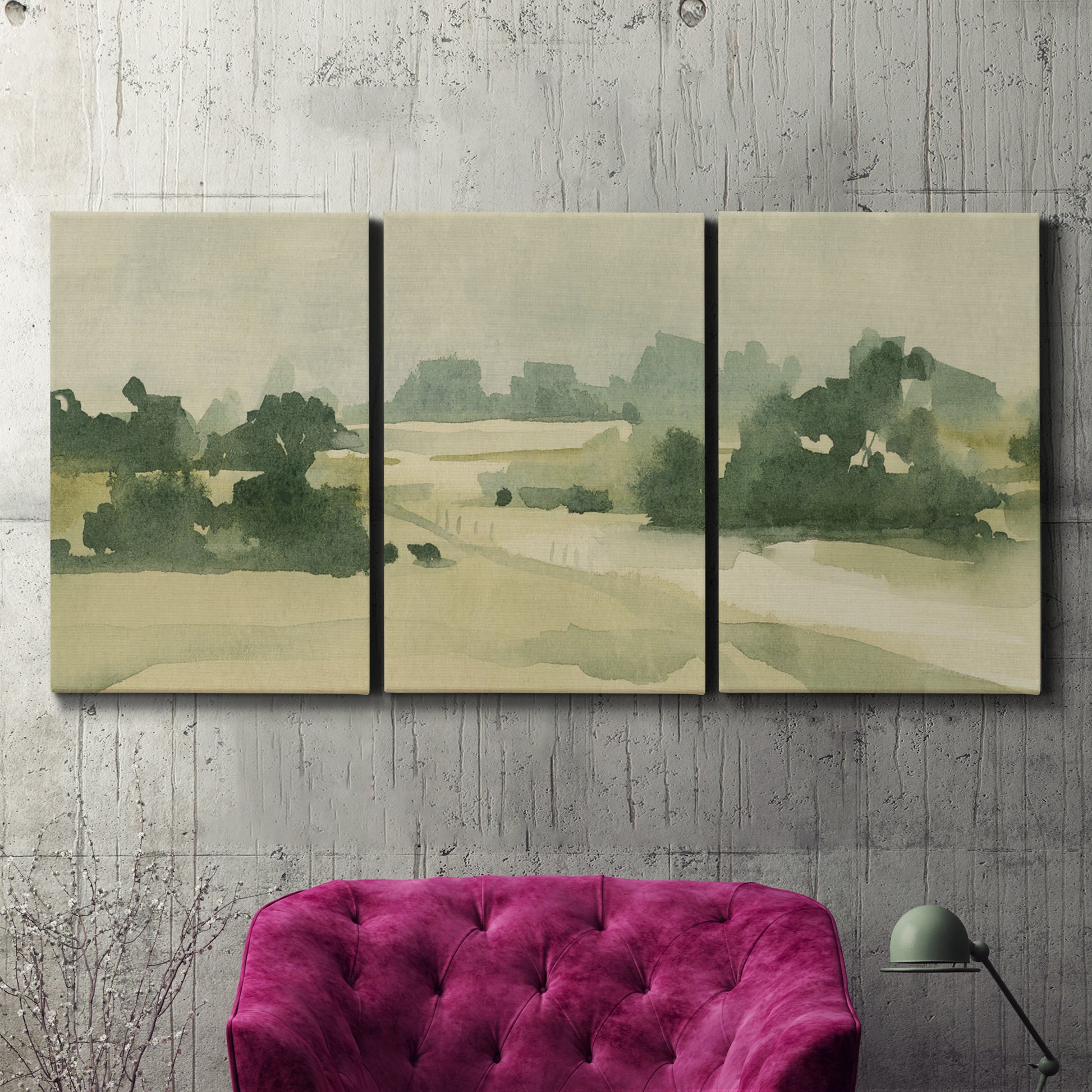Three-panel canvas wall art featuring pasture landscape in soft watercolor, displayed in a living room above a suede accent chair.