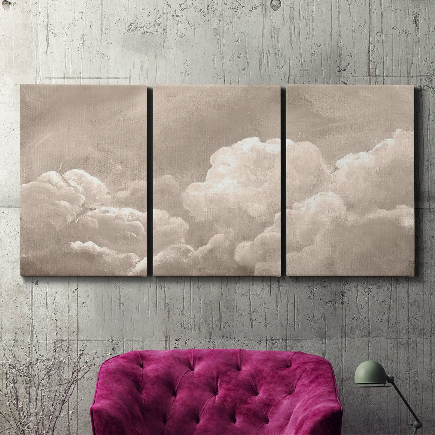 Three-panel canvas wall art featuring soft whimsical cloudscape, displayed in a living room above a suede accent chair.