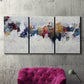 Three-panel canvas wall art featuring abstract water inspired composition, displayed in a living room above a suede accent chair.