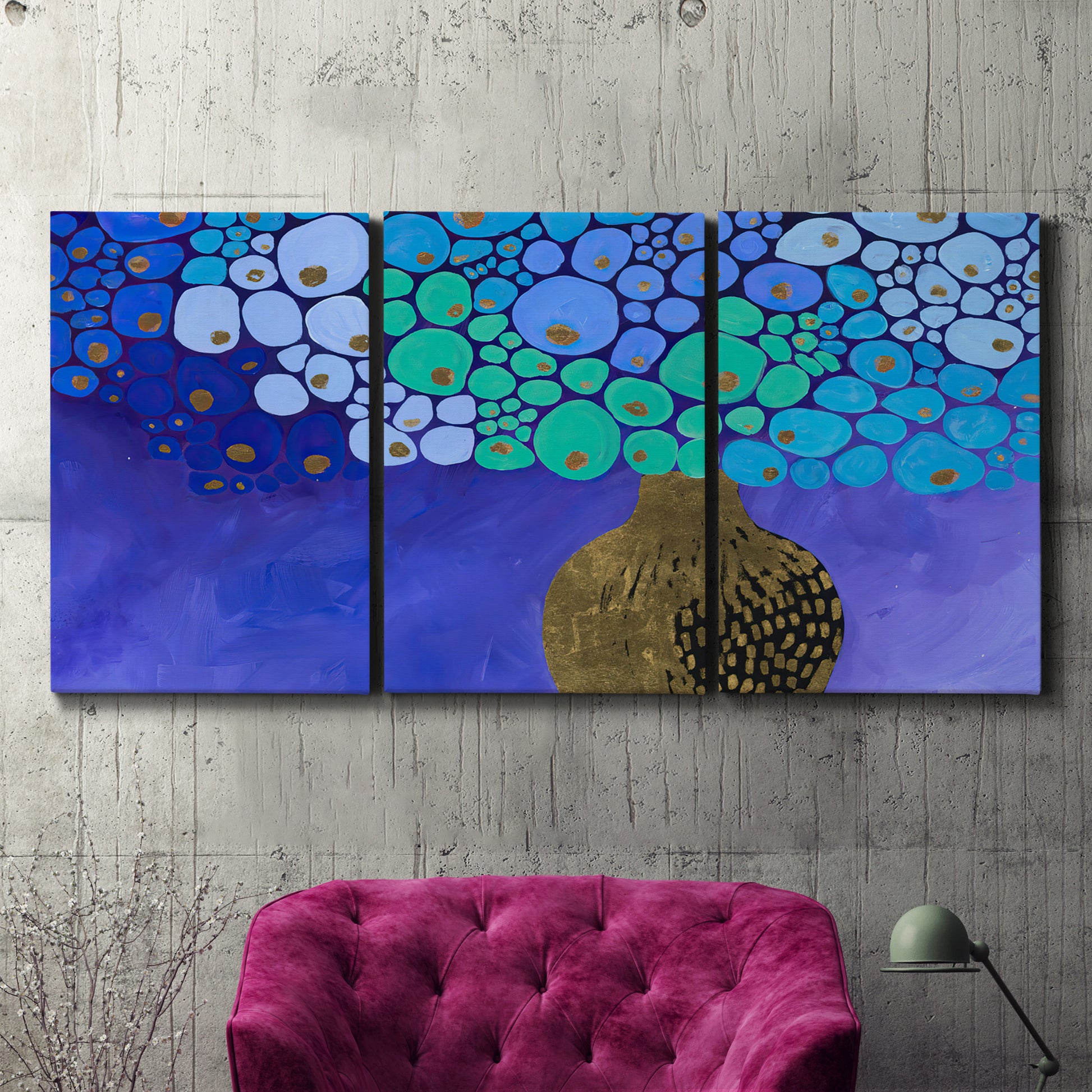 Three-panel canvas wall art featuring blue poppy floral abstraction, displayed in a living room above a suede accent chair.