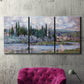 Three-panel canvas wall art featuring summer village view along river, displayed in a living room above a suede accent chair.