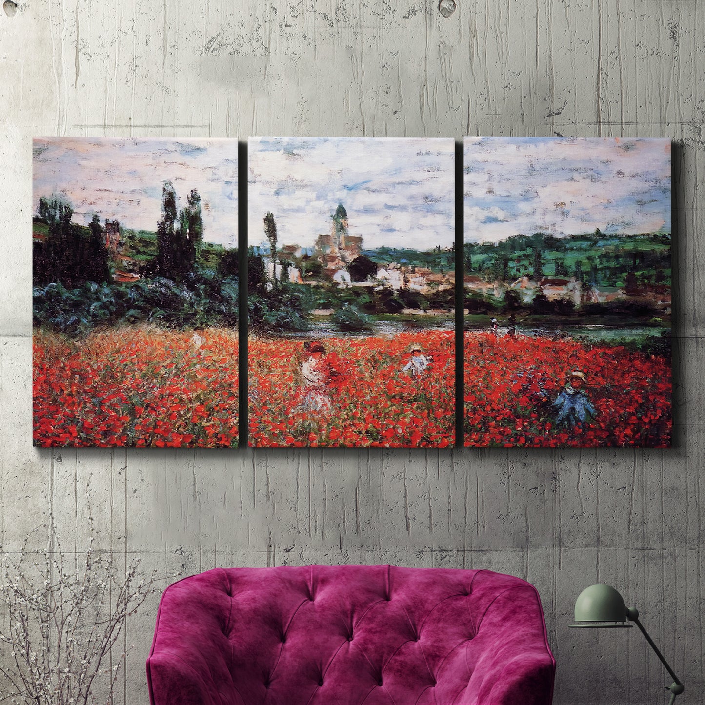 Three-panel canvas wall art featuring poppy field beside village landscape, displayed in a living room above a suede accent chair.