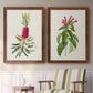Set of two maple barnwood framed canvas prints depicting two vintage botanical plate illustrations featuring pink flowering plant specimens above a sideboard in a cozy sitting room.
