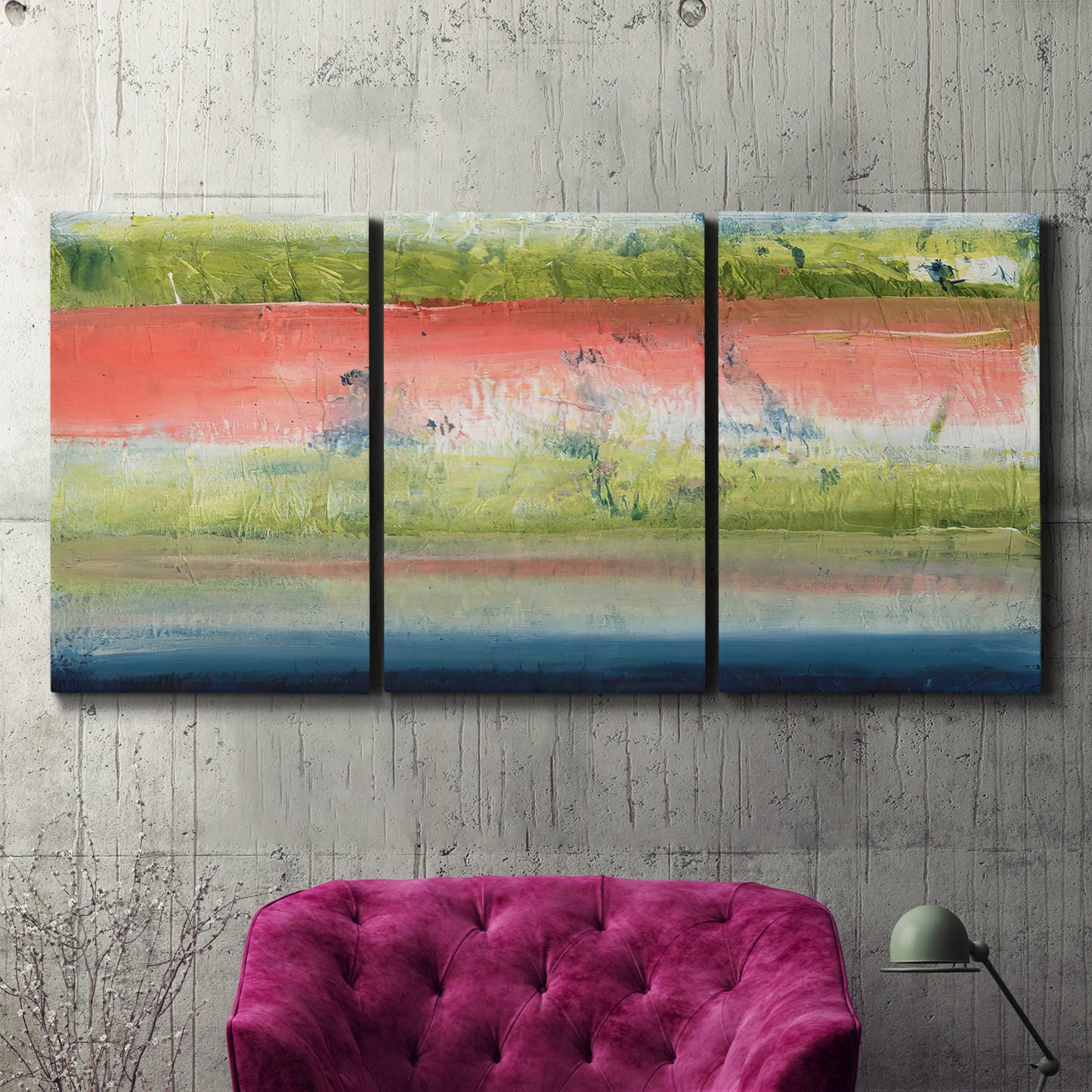 Three-panel canvas wall art featuring layered abstract color banding, displayed in a living room above a suede accent chair.