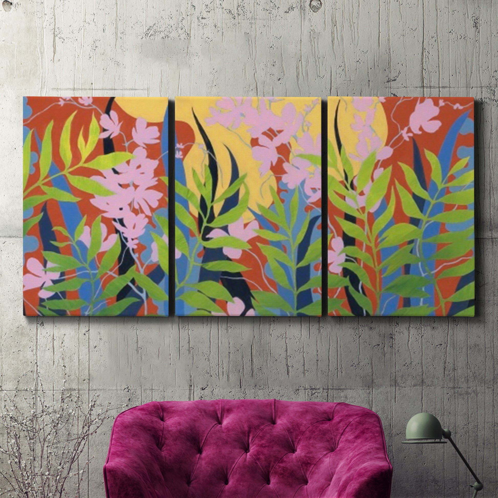 Three-panel canvas wall art featuring bold colorful floral abstraction, displayed in a living room above a suede accent chair.