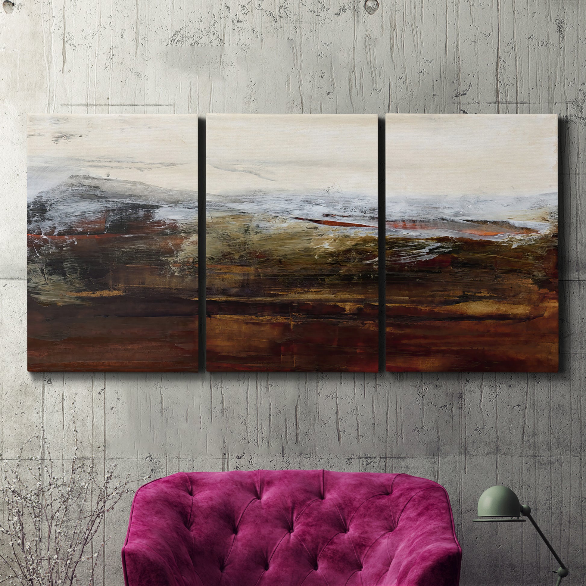 Three-panel canvas wall art featuring rustic abstract landscape exploration, displayed in a living room above a suede accent chair.