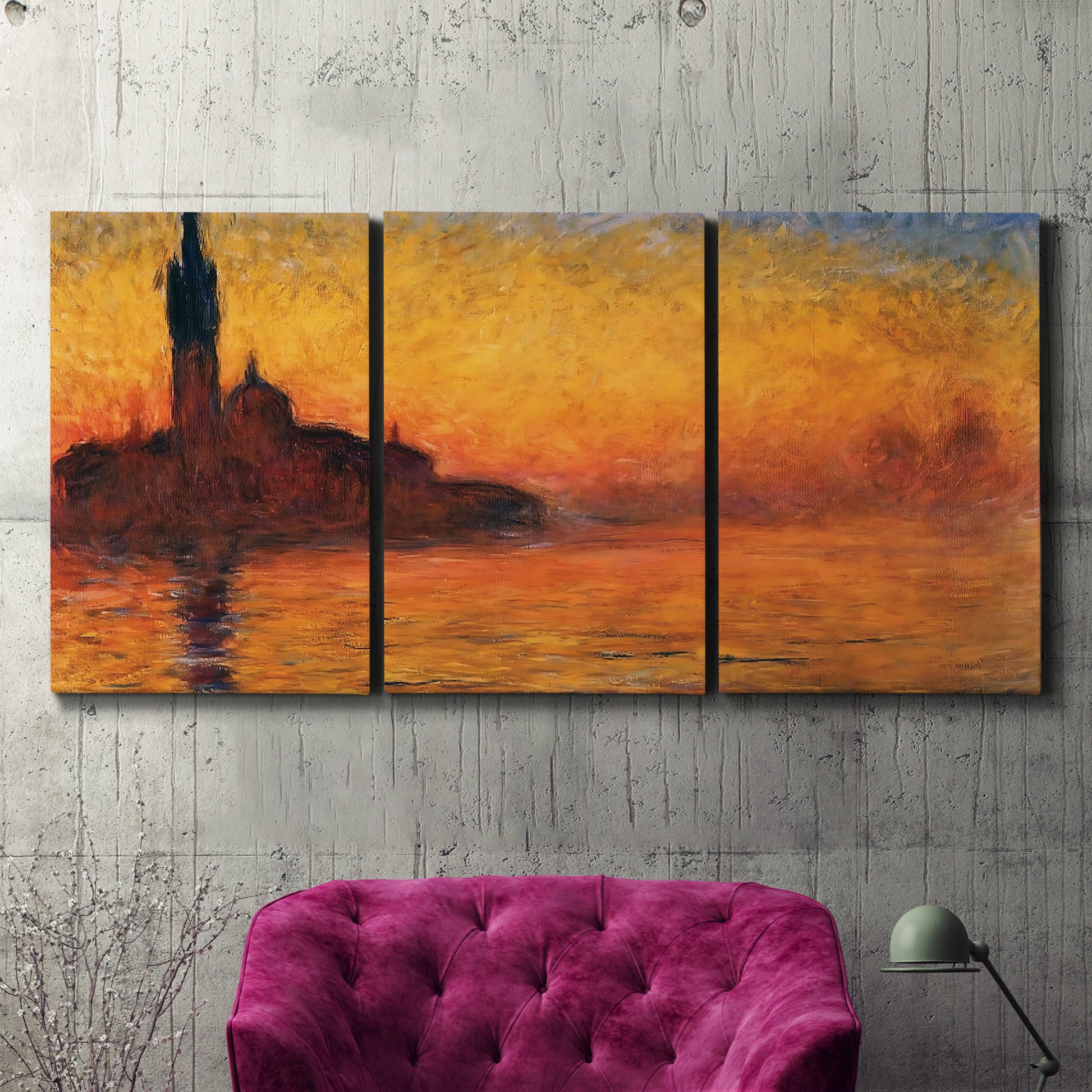 Three-panel canvas wall art featuring Venetian church at sunset, displayed in a living room above a suede accent chair.