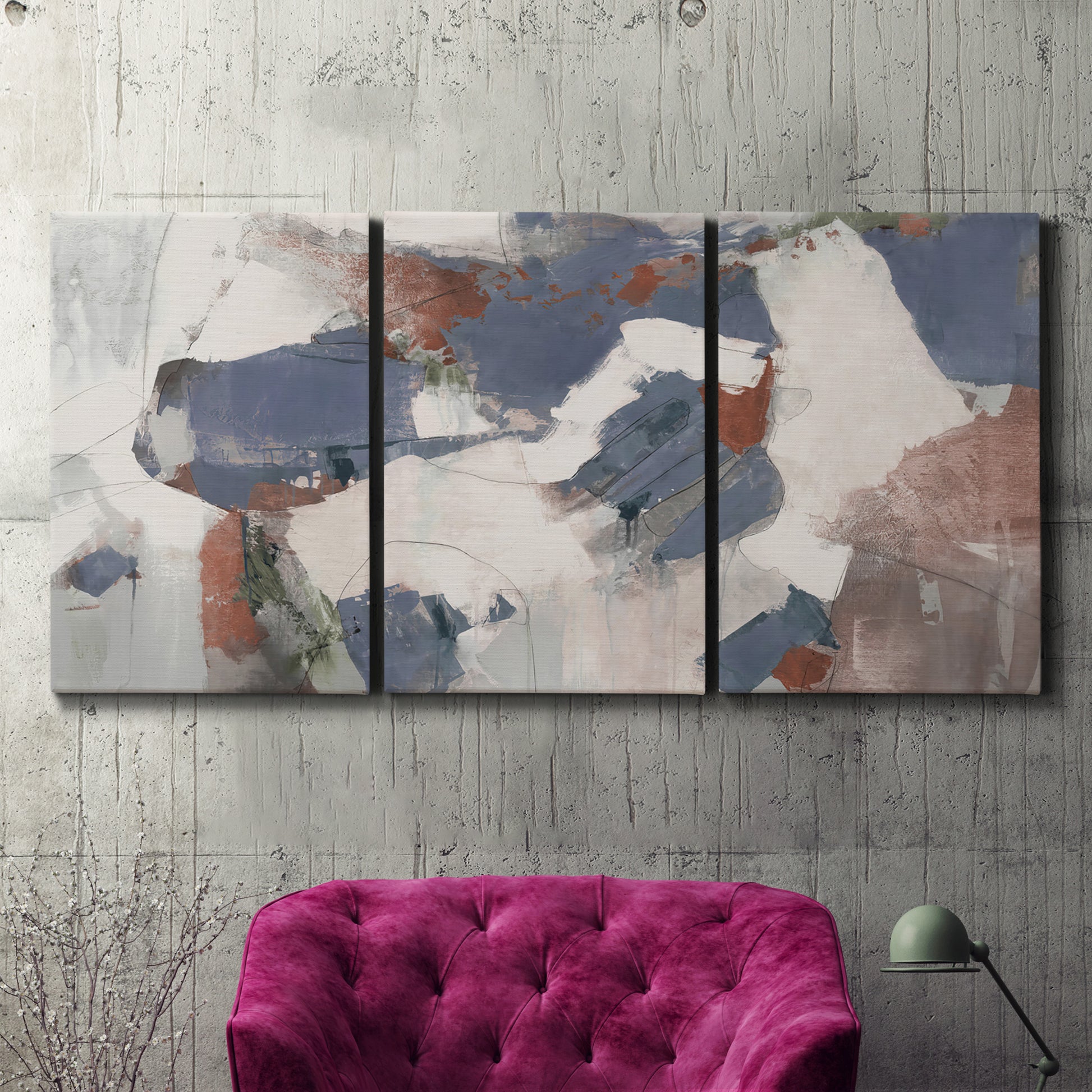 Three-panel canvas wall art featuring cool blue abstract layered composition, displayed in a living room above a suede accent chair.