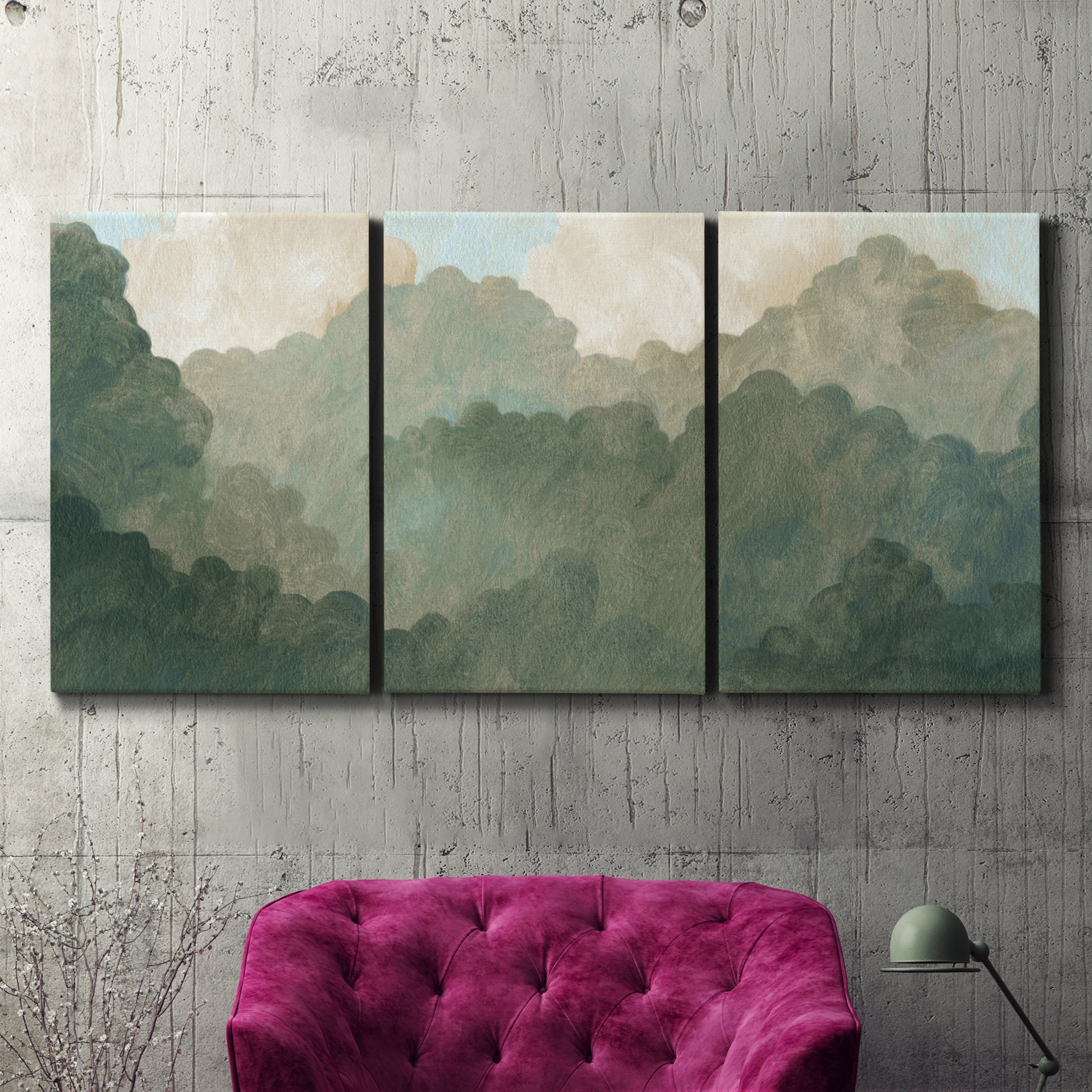 Three-panel canvas wall art featuring autumn storm over rolling landscape, displayed in a living room above a suede accent chair.