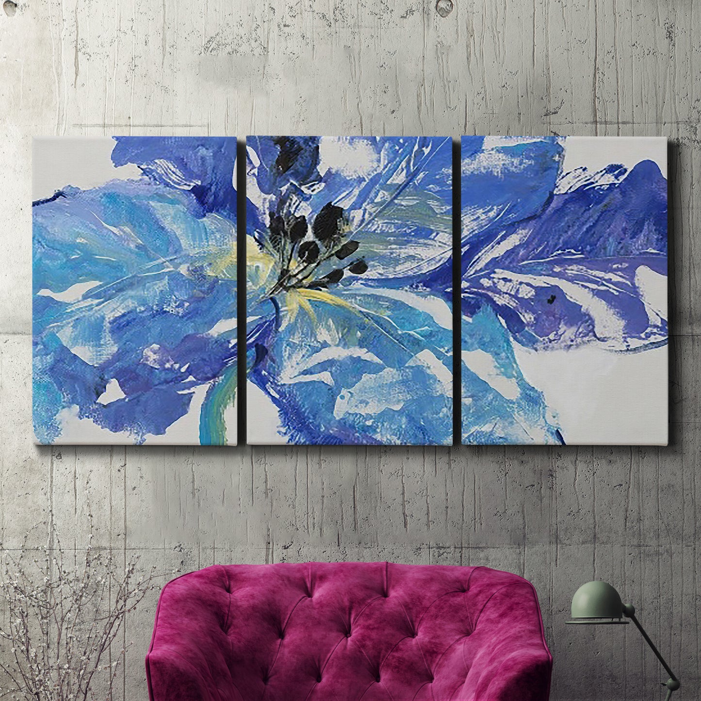 Three-panel canvas wall art featuring blue floral botanical close up, displayed in a living room above a suede accent chair.
