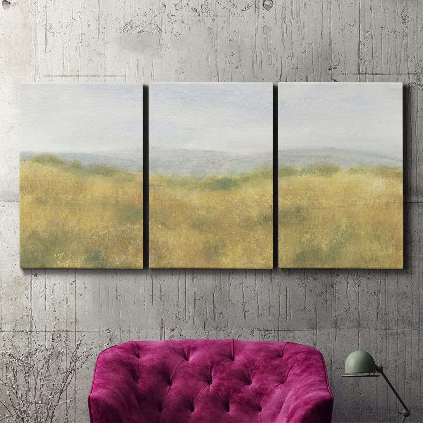 Three-panel canvas wall art featuring pastoral wheat field landscape, displayed in a living room above a suede accent chair.