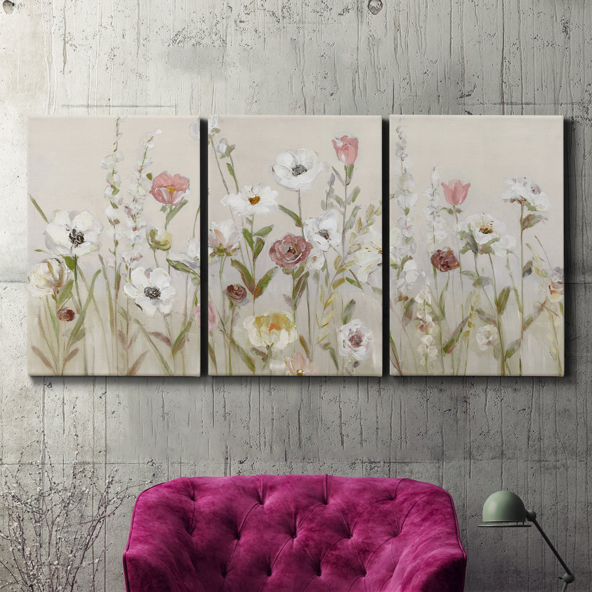Three-panel canvas wall art featuring loose farmhouse style floral painting, displayed in a living room above a suede accent chair.