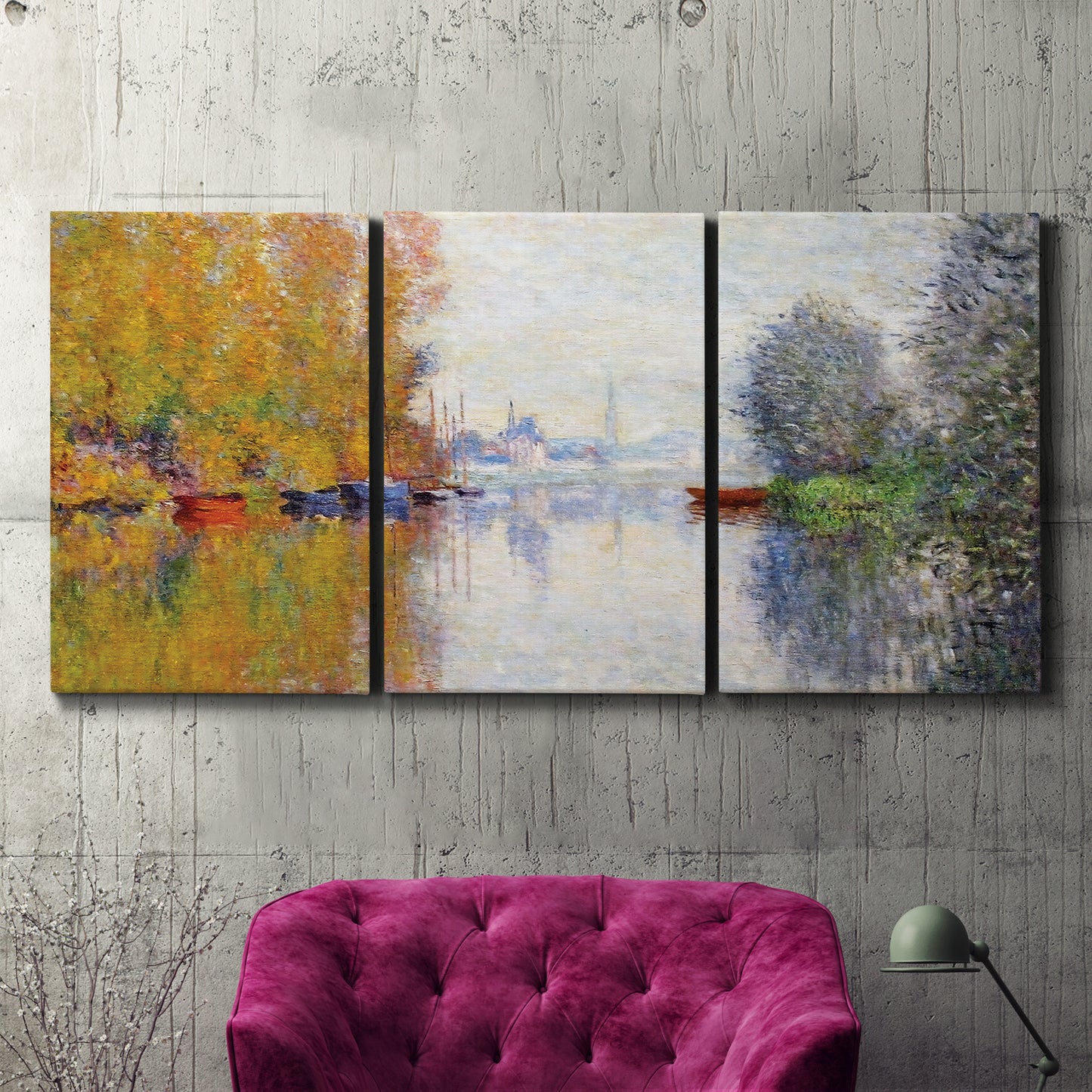 Three-panel canvas wall art featuring golden autumn light over riverside, displayed in a living room above a suede accent chair.