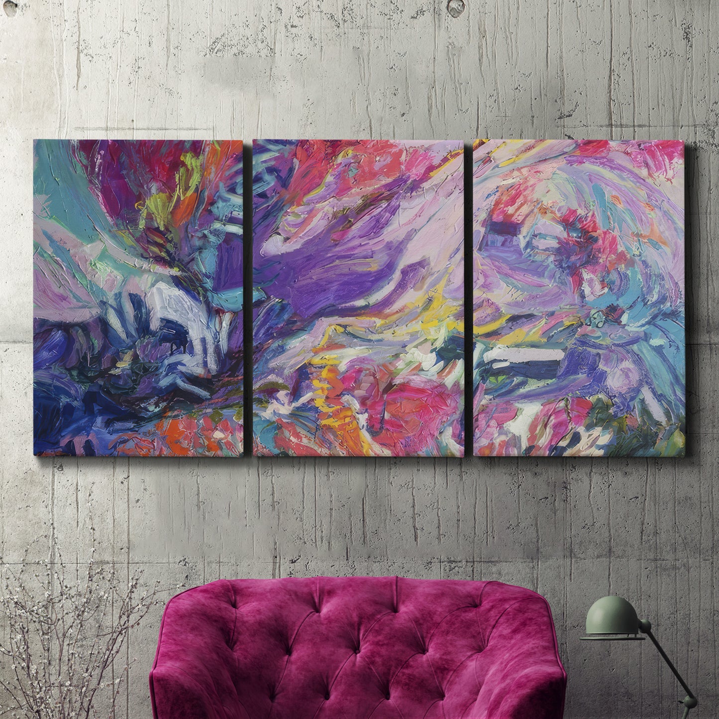 Three-panel canvas wall art featuring expressive abstract with layered color, displayed in a living room above a suede accent chair.
