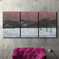 Three-panel canvas wall art featuring winter sunset snowfall landscape, displayed in a living room above a suede accent chair.