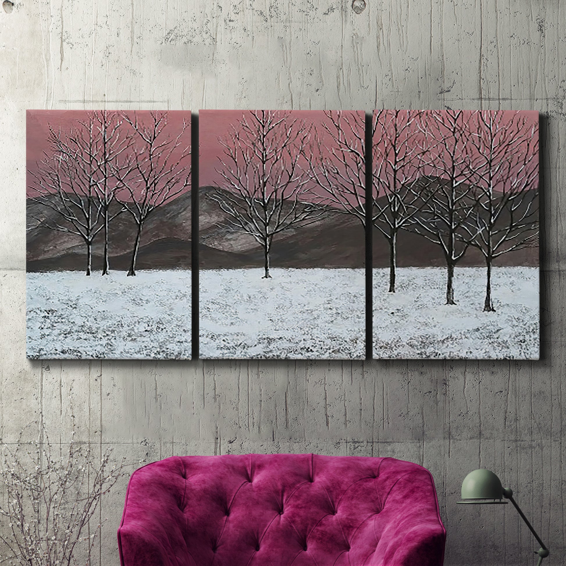 Three-panel canvas wall art featuring winter sunset snowfall landscape, displayed in a living room above a suede accent chair.