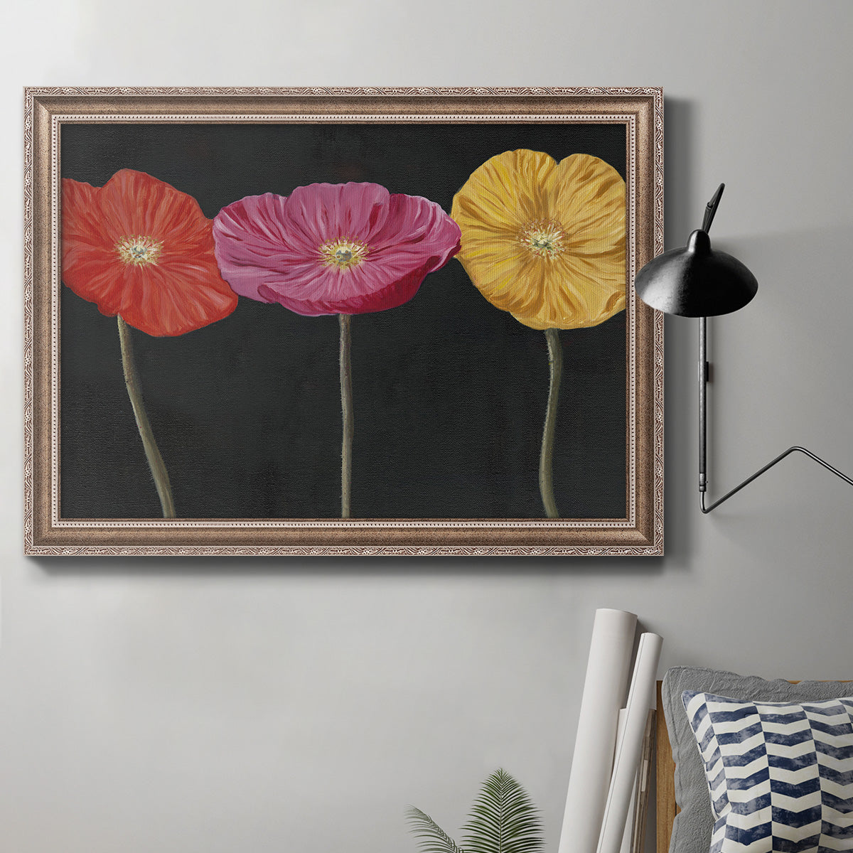 Contemporary poppy flower artwork in an ornate traditional silver frame displayed in a neutral interior setting.