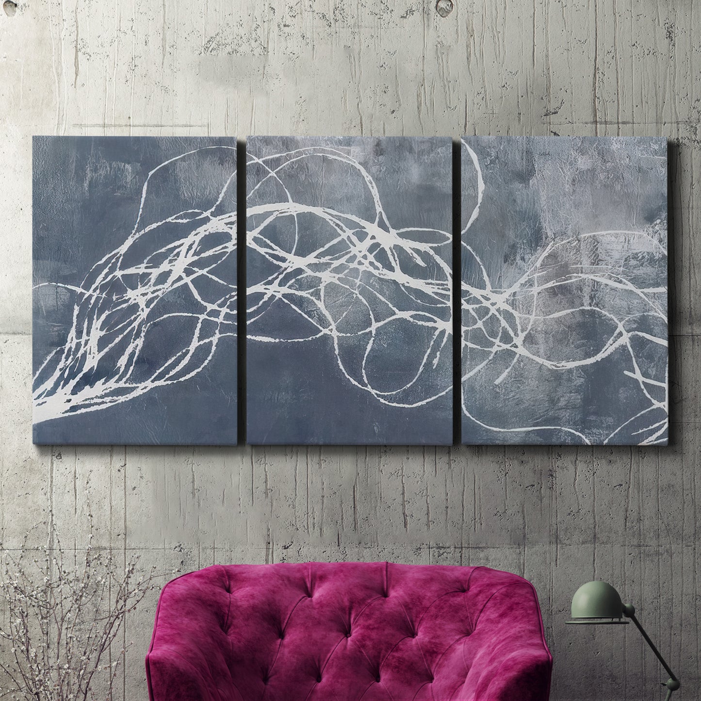 Three-panel canvas wall art featuring coastal shoreline at golden hour, displayed in a living room above a suede accent chair.
