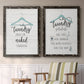 Set of two black barnwood framed canvas prints depicting two rustic typographic wall art featuring humorous laundry-room sayings and clothing icons above a sideboard in a cozy sitting room.