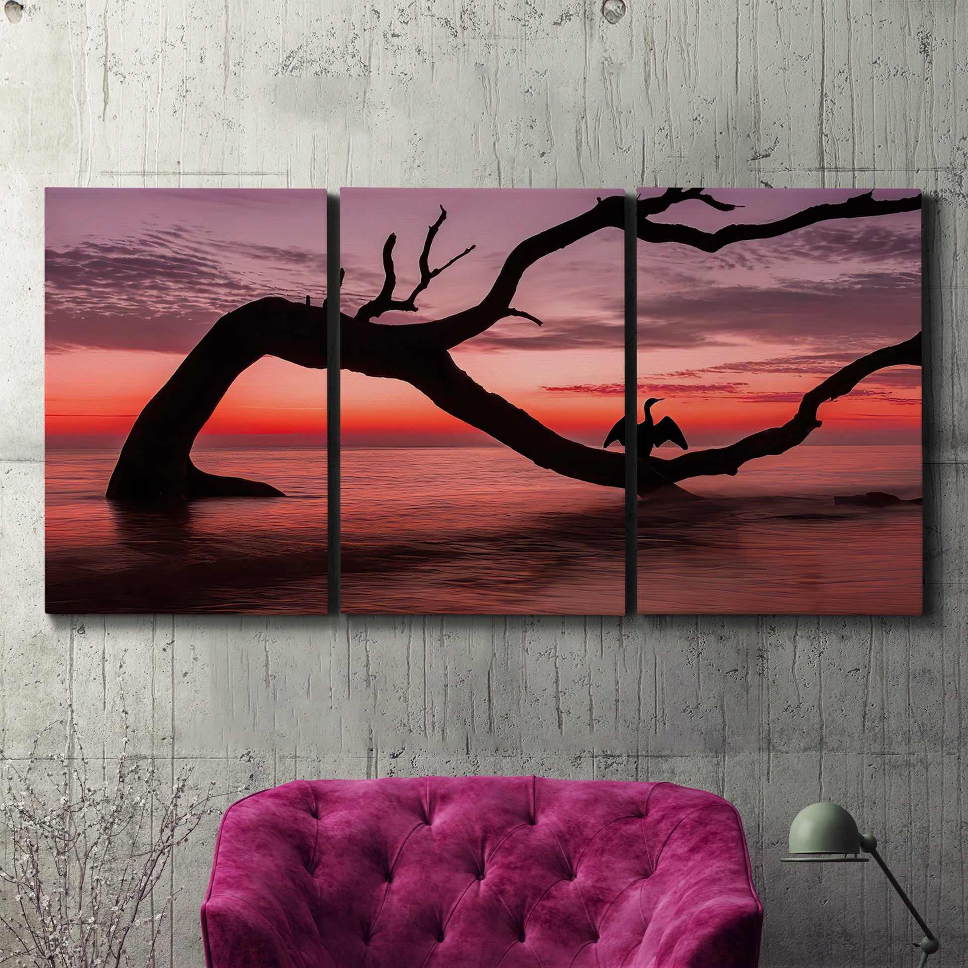 Three-panel canvas wall art featuring sunset beach photography, displayed in a living room above a suede accent chair.