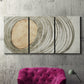 Three-panel canvas wall art featuring circular abstract energy forms, displayed in a living room above a suede accent chair.