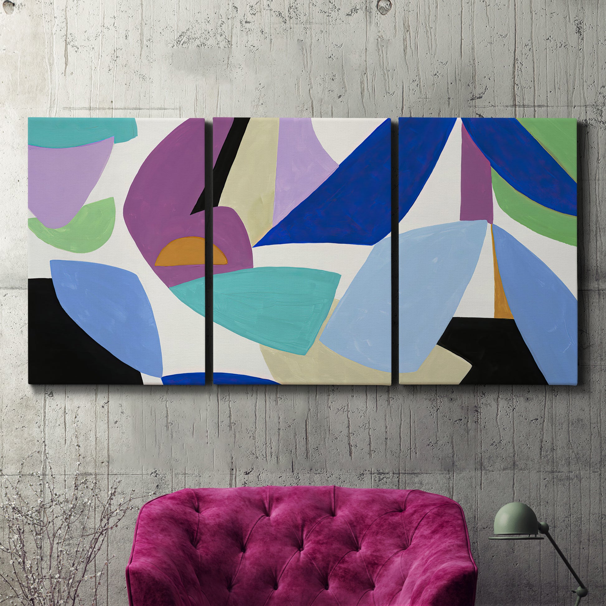 Three-panel canvas wall art featuring colorful abstract homage to modernism, displayed in a living room above a suede accent chair.