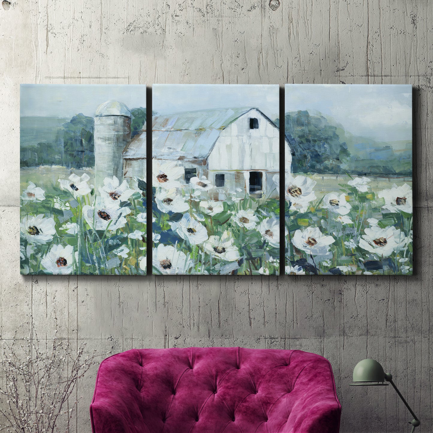 Three-panel canvas wall art featuring pastoral farmland with open fields, displayed in a living room above a suede accent chair.