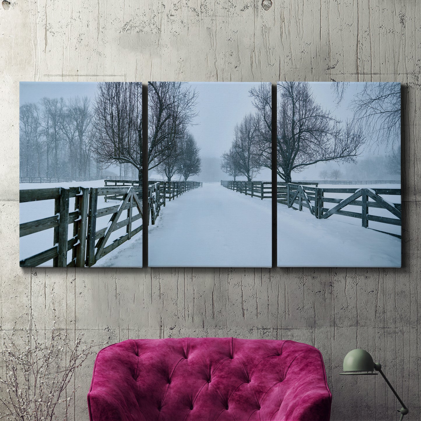 Three-panel canvas wall art featuring snow covered rural road photograph, displayed in a living room above a suede accent chair.