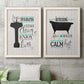 Set of two white barnwood framed canvas prints depicting a coordinated art pair of playful bathtub silhouettes and bath-themed typography rendered as graphic bathroom word art above a sofa in a modern living room.