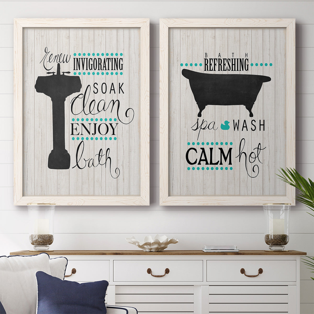 Set of two white barnwood framed canvas prints depicting a coordinated art pair of playful bathtub silhouettes and bath-themed typography rendered as graphic bathroom word art above a dining room sideboard.