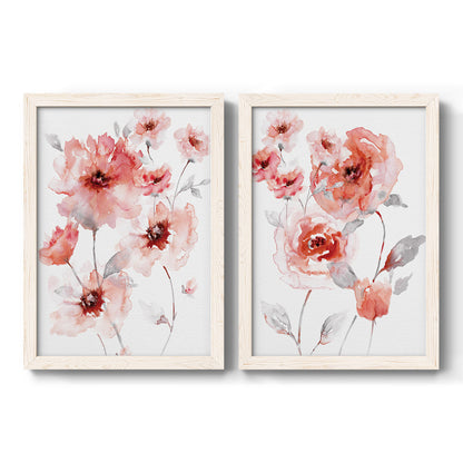 Set of two white barnwood framed canvas prints featuring two airy contemporary watercolor florals featuring loose coral pink blossoms on slender gray stems.