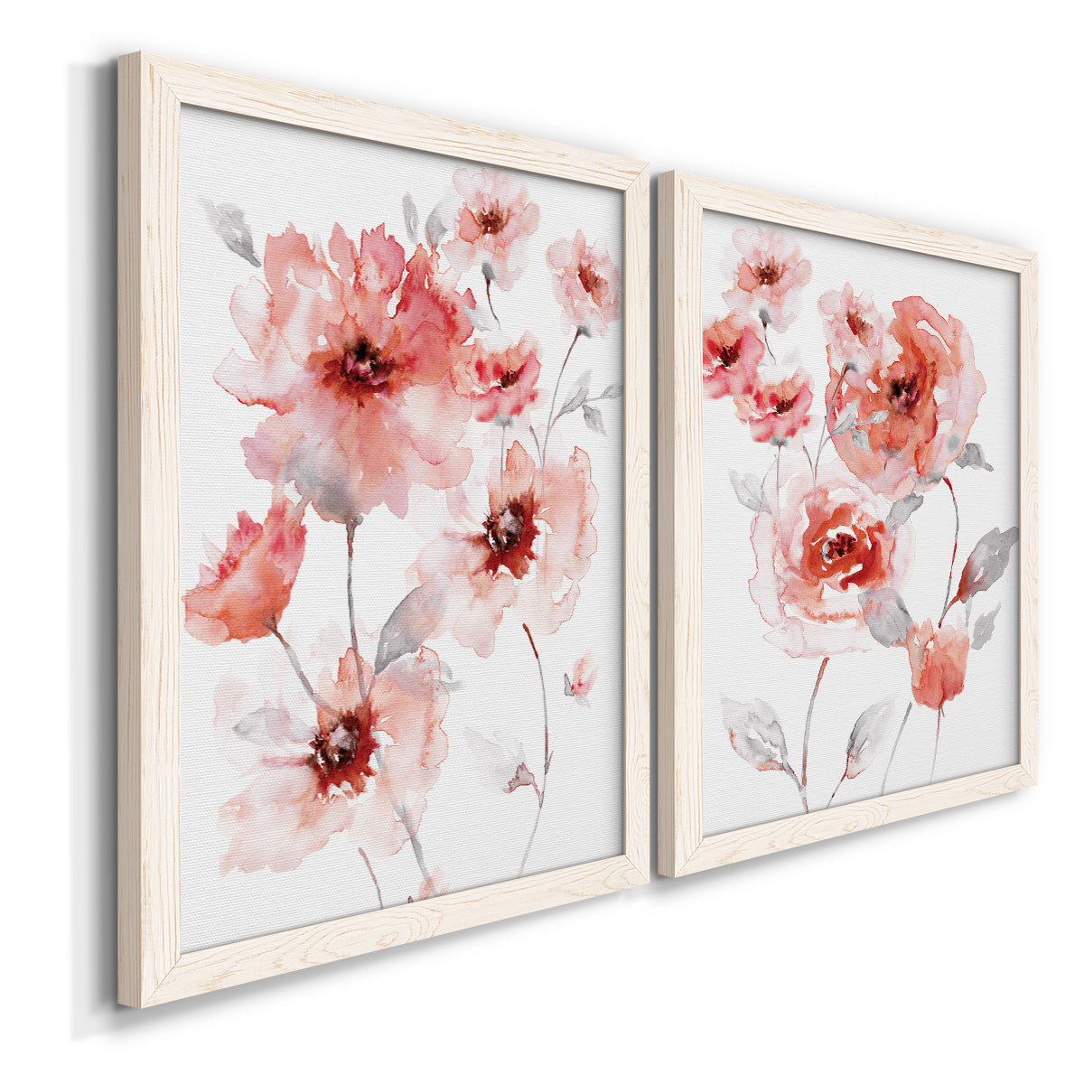 Angled view of a set of two white barnwood framed canvas prints featuring two airy contemporary watercolor florals featuring loose coral pink blossoms on slender gray stems.