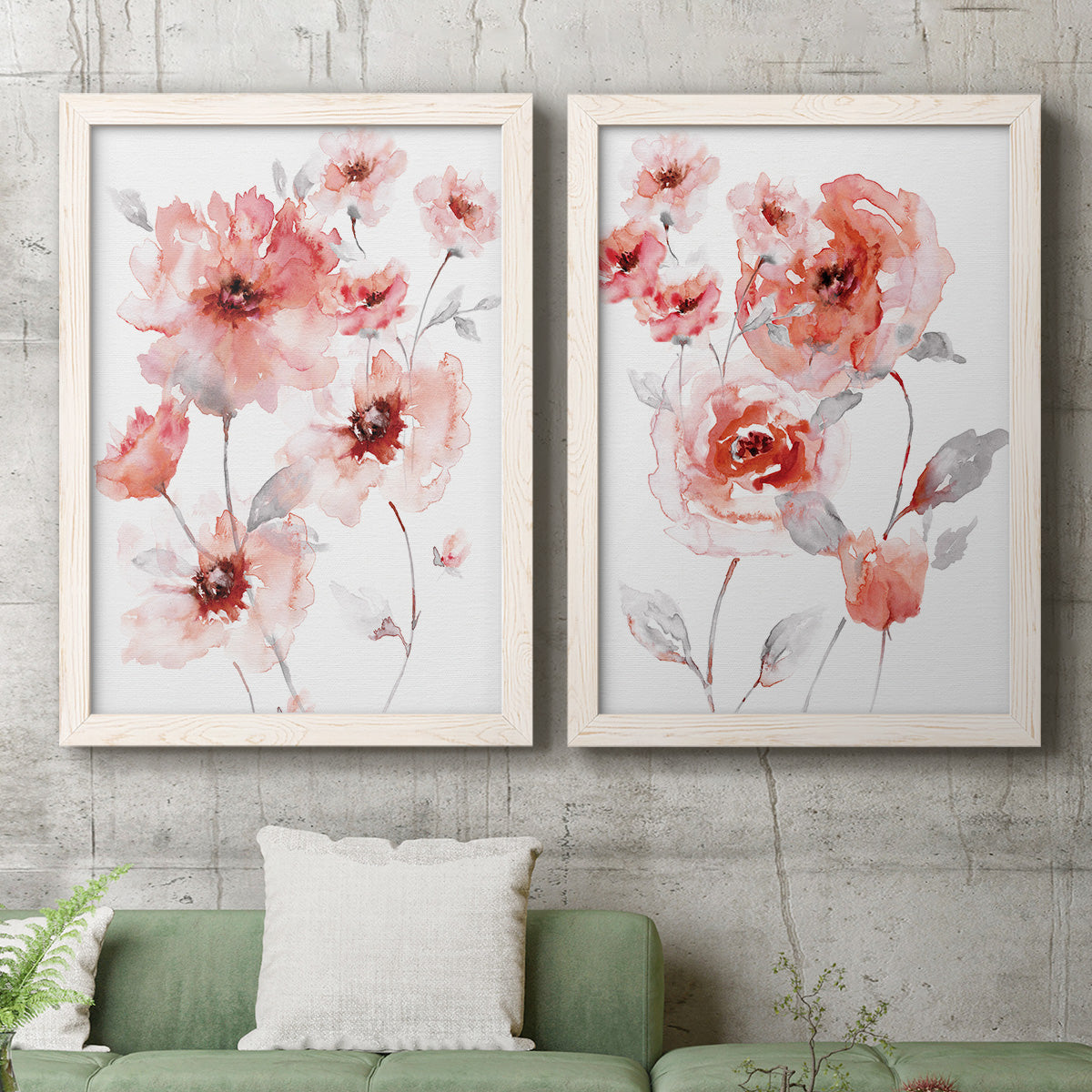 Set of two white barnwood framed canvas prints depicting a coordinated art pair of loose coral pink blossoms on slender gray stems rendered as airy contemporary watercolor florals above a sofa in a modern living room.