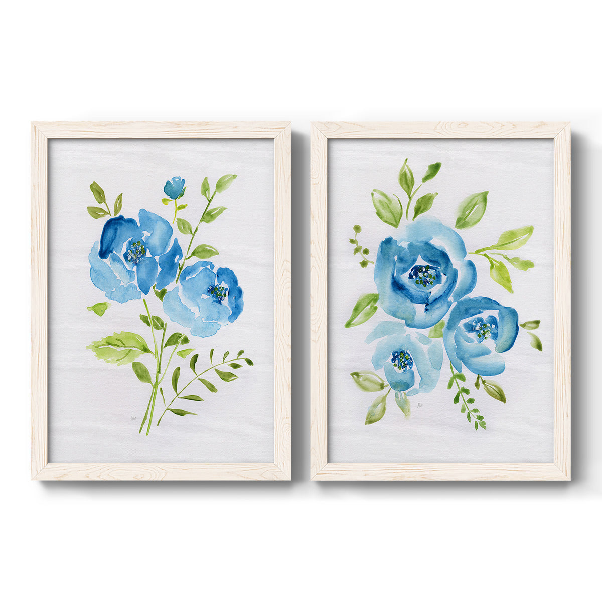 Set of two white barnwood framed canvas prints featuring two contemporary botanical paintings featuring blue watercolor flowers with fresh green leaves.