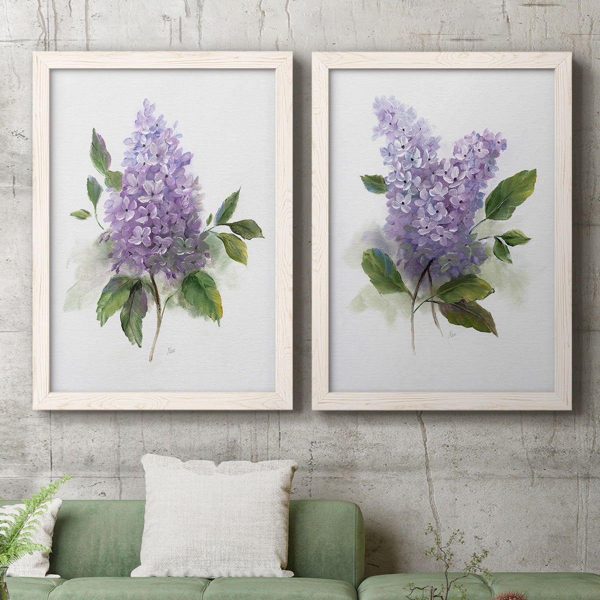 Set of two white barnwood framed canvas prints depicting a coordinated art pair of full purple lilac clusters with green leaves rendered as romantic traditional floral paintings above a sofa in a modern living room.