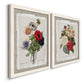 Angled view of a set of two white barnwood framed canvas prints featuring two traditional botanical collage prints featuring vintage mixed-flower bouquets on distressed paper.